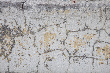 concrete surface covered with paint cracked under the influence of time