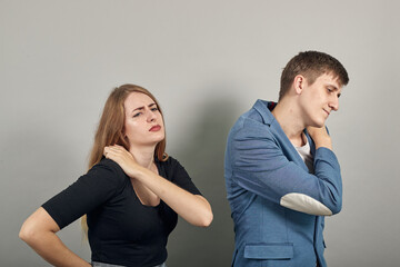 Holds the shoulder hurts, pain in my arm, sore point, problem with health care and exercise. Feel hurt. Terrible ache in spine. Exercises for back. Young attractive couple boyfriend girlfriend two