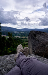 landscape in first person with stones in the foreground, trees and clouds in the background
