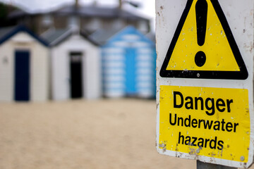 danger sign and beach huts