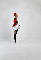 Obraz premium beautiful girl in red hussar uniform marching with a sword