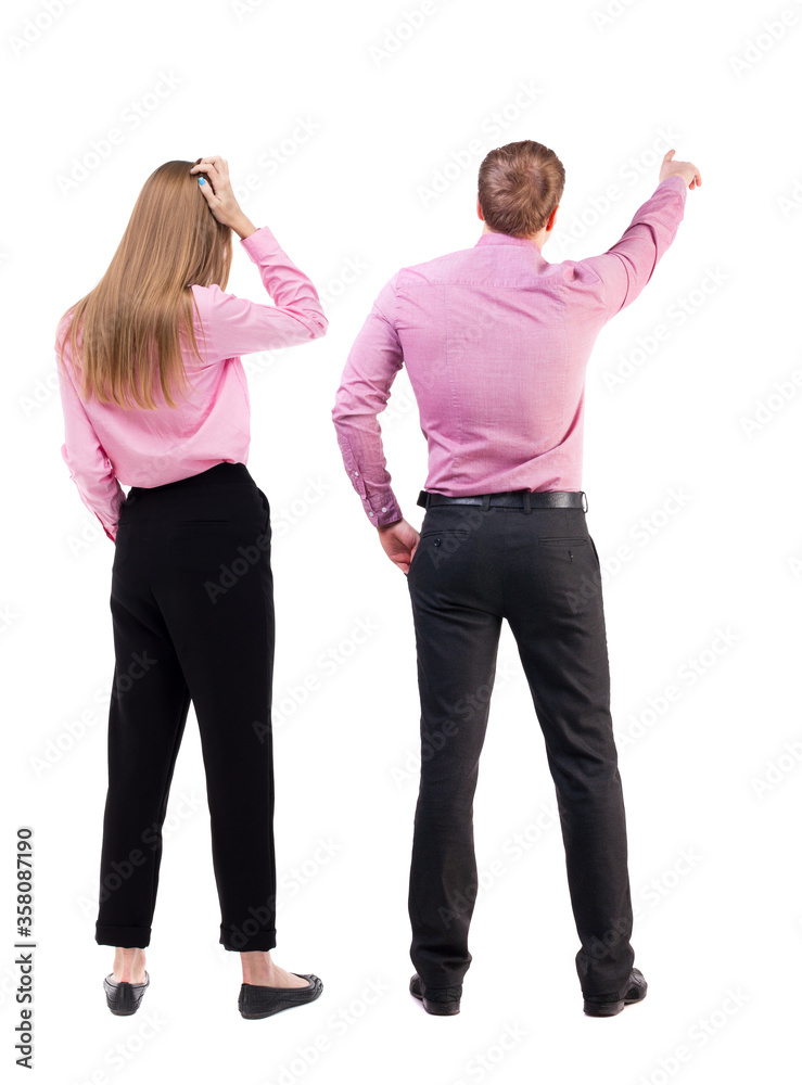 Wall mural back view of business man and business woman in suit pointing.