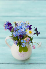 spring flowers on turquoise wooden surface