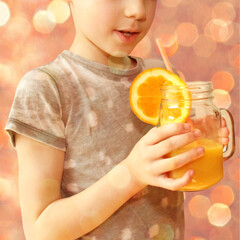 cheerful kid, boy, holds a glass jar in his hand with orange juice from orange or lemon and drinks from a straw, the concept of a healthy diet, vitamins, lifestyle