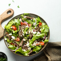 Green salad with beef steak and fresh cheese