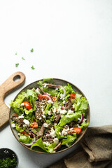 Green salad with beef steak and fresh cheese