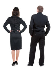Back view of business woman and business man in suit.