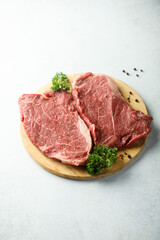 Raw beef steak on a wooden desk
