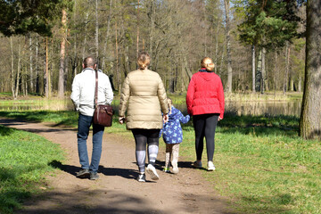 Fototapeta premium family walking in the park