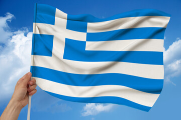 National flag of the country Greece on delicate silk with wind folds, travel concept, immigration, politics, copy space, close-up