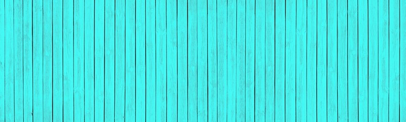 Bright turquoise painted old wooden boards. Light teal colored wood texture. Wide rustic background