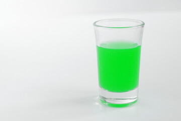 Glass of green alcohol. Shot of green in a glass.