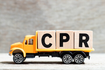 Truck hold letter block in word CPR (abbreviation of Cardiopulmonary resuscitation) on wood background
