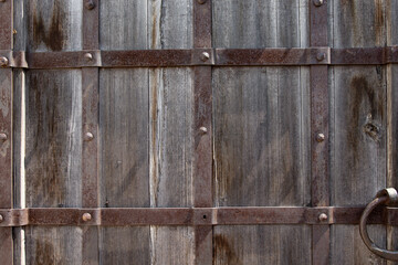 Image of old wooden door with metal knob © vbaleha