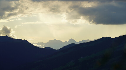 beautiful sunset on the mountains with clouds and sunligth and view to the alps
