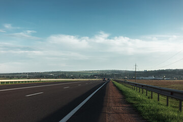 Morning view of asphalting road in sunny day with pure sky.