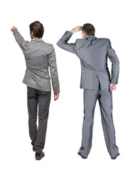 Back view of two business men in suit pointing.