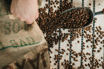 A hand With Coffee Beans On A Light Background
