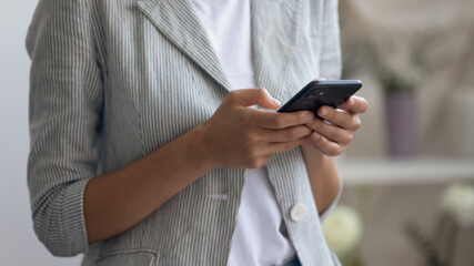 Close up crop view of woman hold smartphone gadget texting or messaging using wireless internet, female busy surf browse web on modern cellphone device, consult client online, technology concept