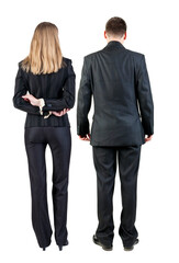 Back view of business woman and business man in suit.