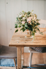 Wedding flower Bouquet standing in a vase on a wooden table