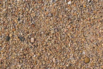Wet gravel surface for backdrop. Color - shades of brown, ice.