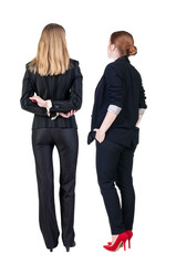 Back view of two business woman in suit.