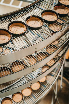 Pies in a bakery on a coveyor belt