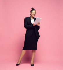 Tablet scrolling. Young woman in office attire. Bodypositive female character, feminism, loving herself, beauty concept. Plus size businesswoman, elegant teacher, beautiful girl. Inclusion, diversity.