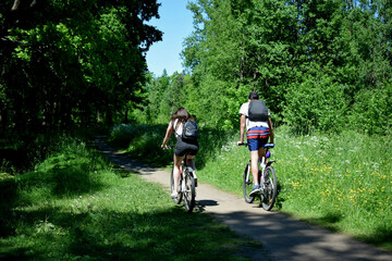 Fototapeta premium young couple riding bikes in park