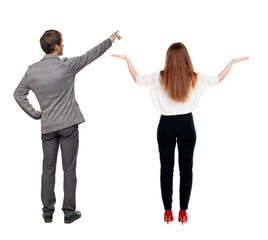 Back view of business man and business woman in suit pointing.
