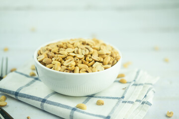 Roasted peanuts in white bowl