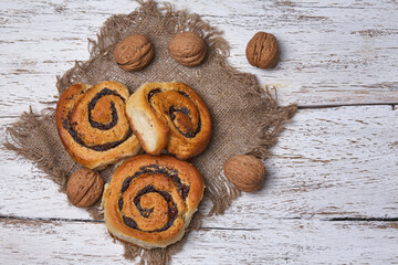 Tasty buns with raisins on a white rustic wooden table. fresh bakery. breakfast. bread. top view