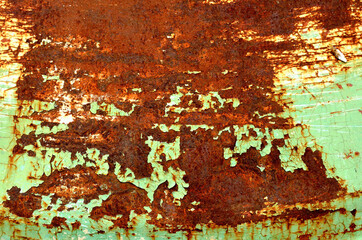 Specks of rust on old green painted metal texture pattern background.