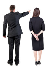 Back view of business man and business woman in suit pointing.