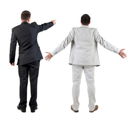 Back view of business man and business woman in suit pointing.