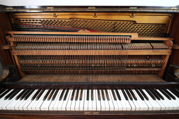  piano vintage upright with black and white keys and interior parts visible  