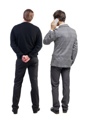 Back view of two business man in suit with mobile phone.