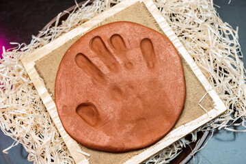 handprint on brown clay. right hand