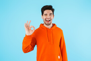 Positive young bristle man showing okay gesture.