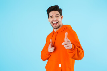 Happy young bristle man isolated over blue wall