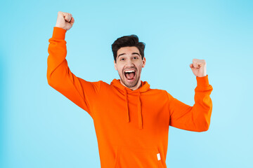 Emotional optimistic young bristle man make winner gesture.