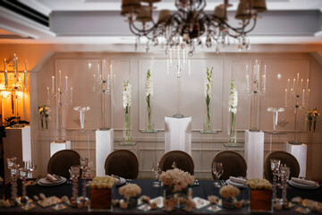 interior of a luxury hotel. wedding decoration in a restaurant. Candles and cutlery on the tables.