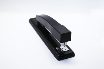 Manual stapler, a tool that allows you to staple a sheet of paper or cardboard through a piece of...