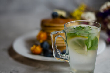 pancakes with honey, berries and cold mojito