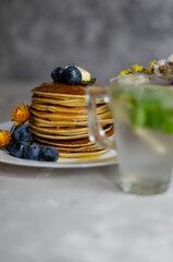 pancakes with honey, berries and cold mojito
