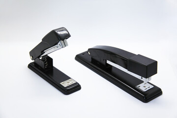 Manual stapler, a tool that allows you to staple a sheet of paper or cardboard through a piece of...