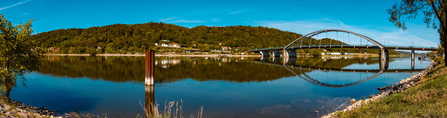 High resolution stitched panorama of a beautiful spring view with reflections and a bridge at Vilshofen, Danube, Bavaria, Germany