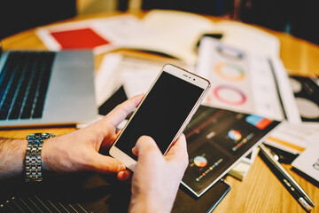 Cropped view of man's hands chatting online in social networks on smartphone device using 4G internet connection.Installing application on telephone device