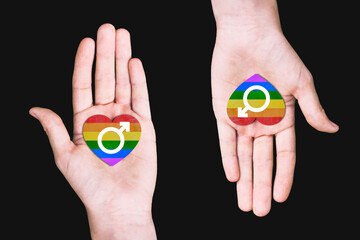 Same-sex marriage concept. Two male hands with hearts and a gender sign. Symbol of the LGBT community. Gay love. LGBT Pride Month.